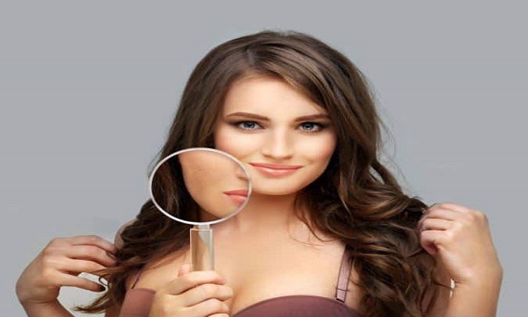 Woman holding a magnifying glass to her face to highlight skin details