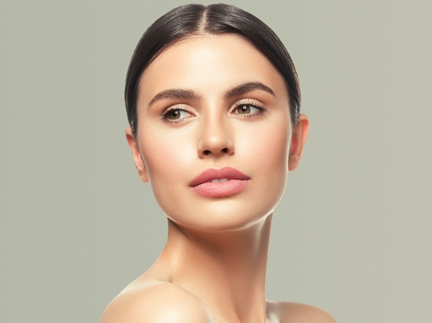 Woman with smooth glowing skin posing for a beauty skincare portrait