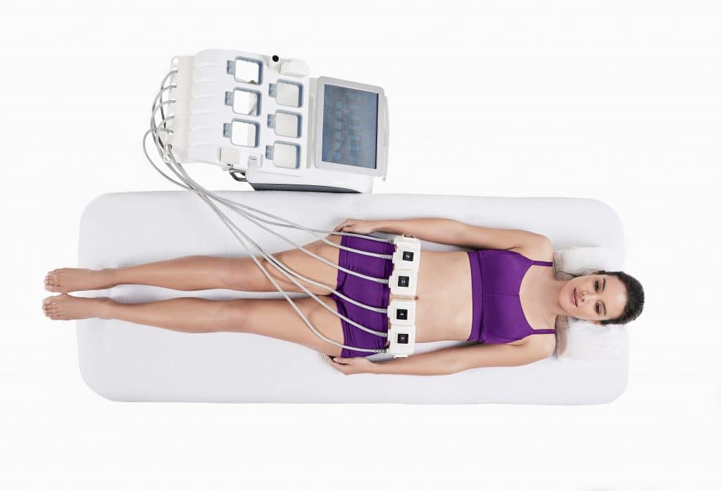 woman laying on a table at Manhattan Aesthetics getting a Trusculpt treatment on her stomach