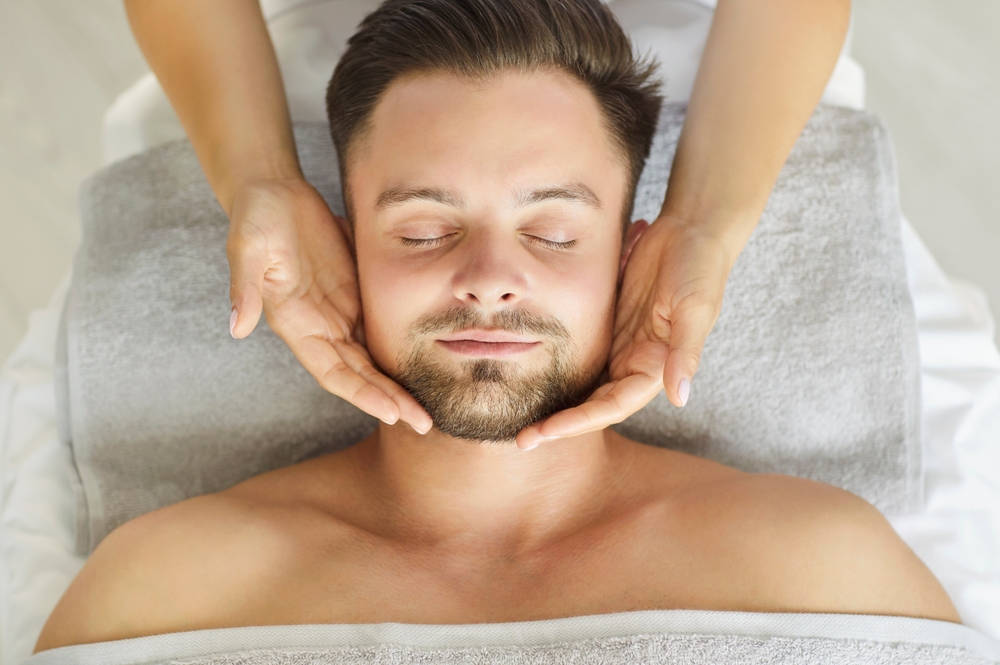 Man laying down getting a facial procedure